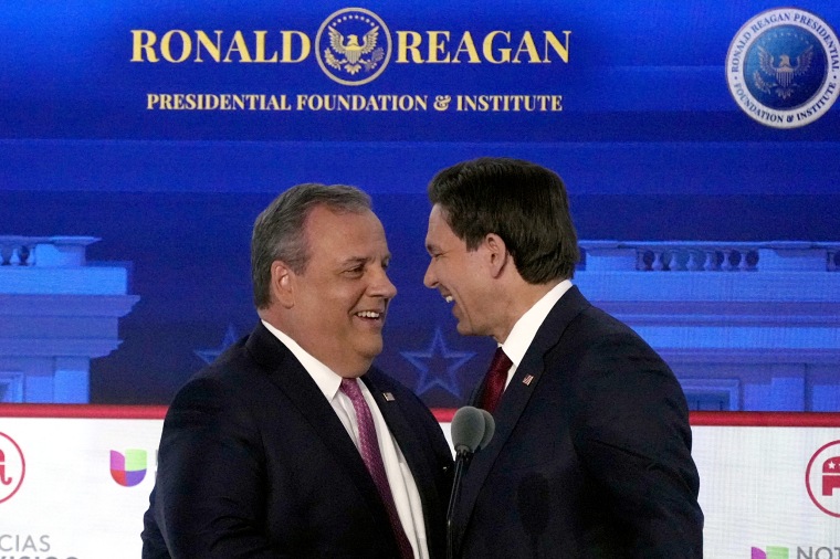 Image: Chris Christie and Ron DeSantis share a laugh on the debate stage.