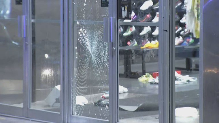 Shattered glass and merchandise on the floor at a Foot Locker Philadelphia that was looted Tuesday, Sept. 26, 2023.