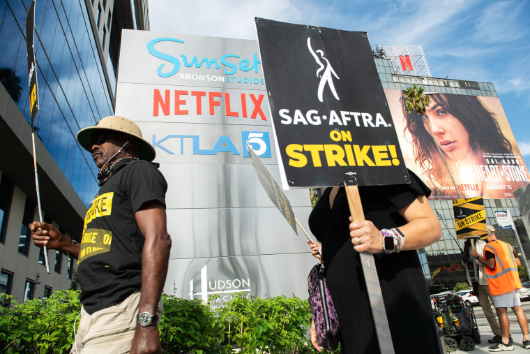 Members of the Screen Actors Guild walk a picket line outside of Netflix in Los Angeles, California, on September 27, 2023. The Writers Guild of America has been on strike since early May and the SAG-AFTRA actors' union joined the writers on the picket lines in July.