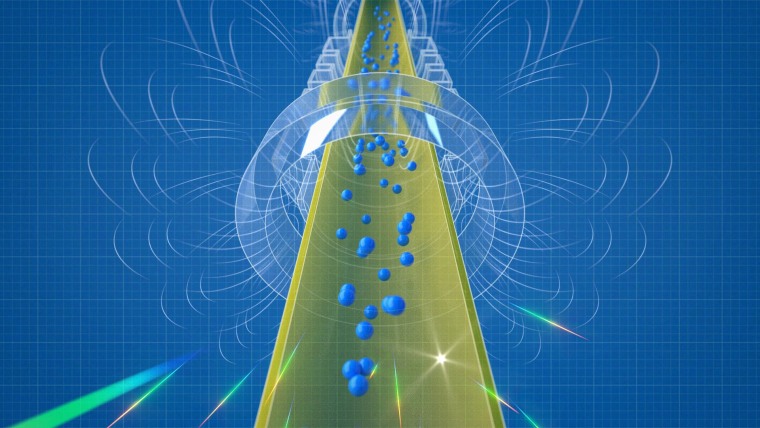 An illustration depicts antihydrogen atoms falling out the bottom of the magnetic trap of the ALPHA-g apparatus, a tall cylindrical vacuum chamber. As the antihydrogen atoms escape, they touch the chamber walls and annihilate. Most of the annihilations occur beneath the chamber, showing that gravity is pulling the antihydrogen down.