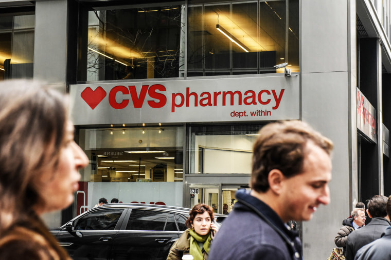 People walk past CVS in New York