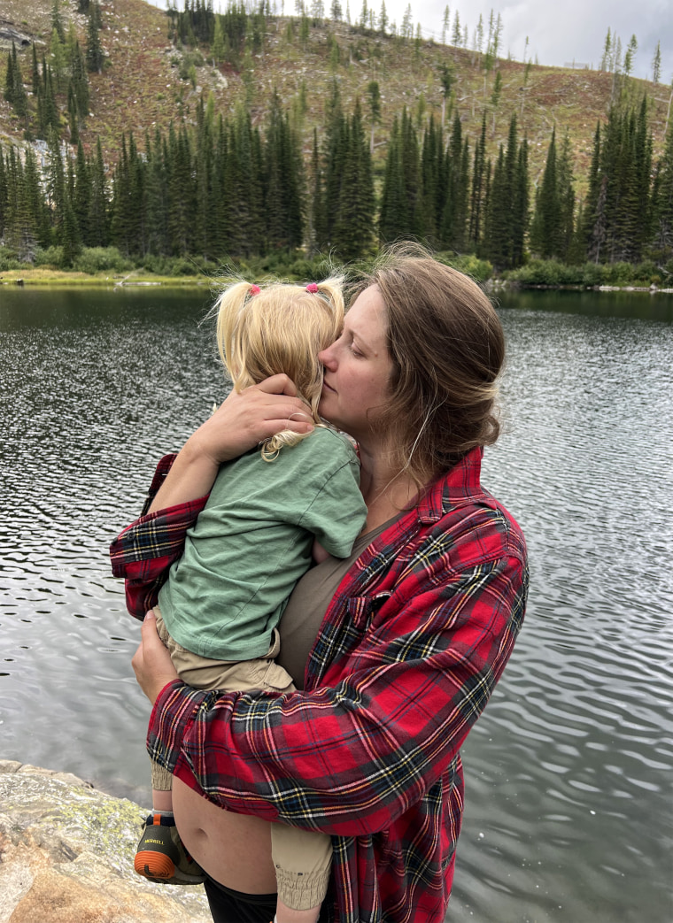 Image: Lauren Sanders, six months pregnant, holds her daughter, 2 and a half.