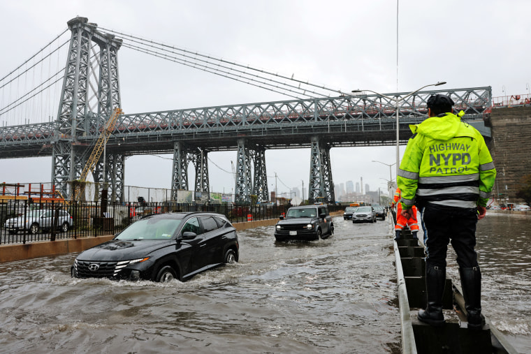 Motorists drive through floodwaters on FDR Drive in Manhattan near the Williamsburg Bridge on Friday, Sept. 29, 2023.