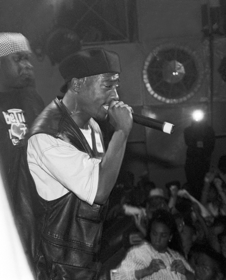 Tupac Shakur holding microphone. 
