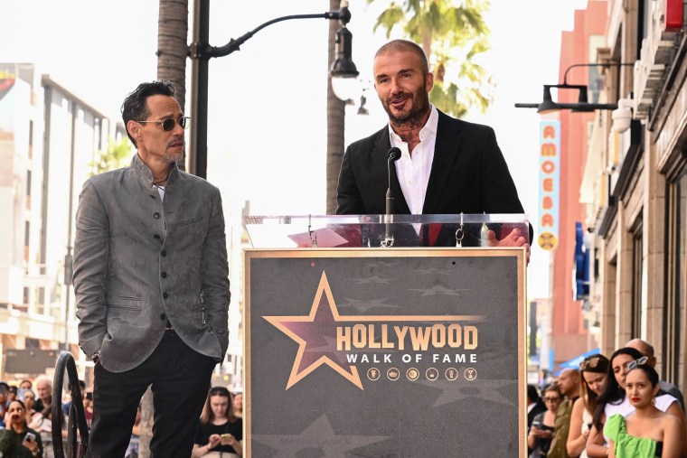 US singer Marc Anthony (L) is presented a star by Inter Miami's co-owner David Beckham on the Hollywood Walk of Fame during a ceremony in Hollywood, California on September 7, 2023. 