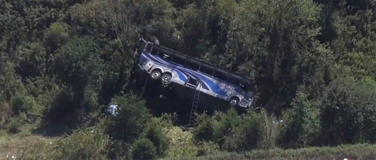 Two adults were killed and more than 40 other people were injured when the bus tumbled off the highway, officials said. 