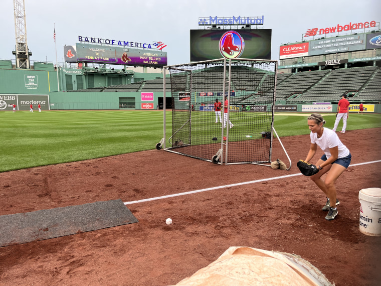 Dylan Dreyer practices catching a ball before putting her skills to the test during a Boston Red Sox game.