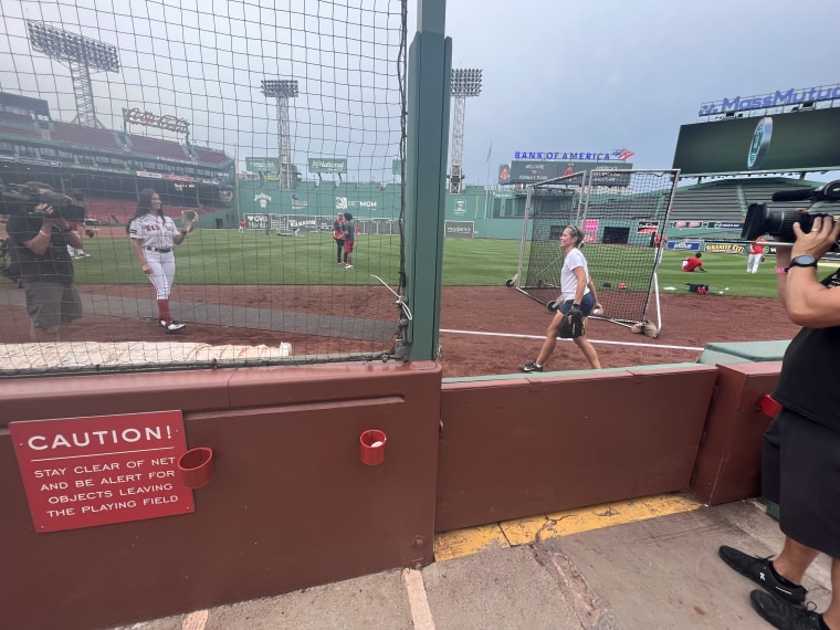 Dylan Dreyer warms up for her gig as a ball attendant, who's responsible for fetching stray baseballs during the game, for the Boston Red Sox.