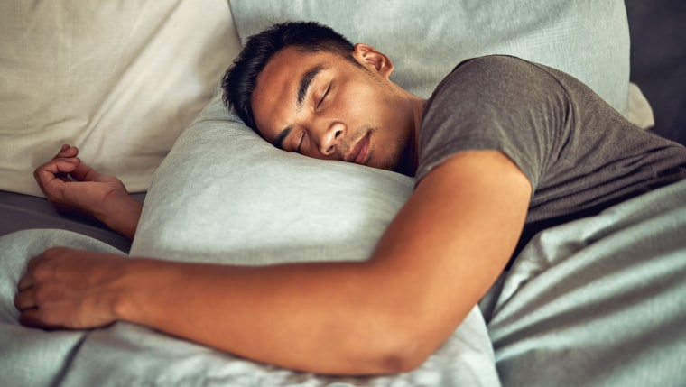 Shot of a young man sleeping in bed.