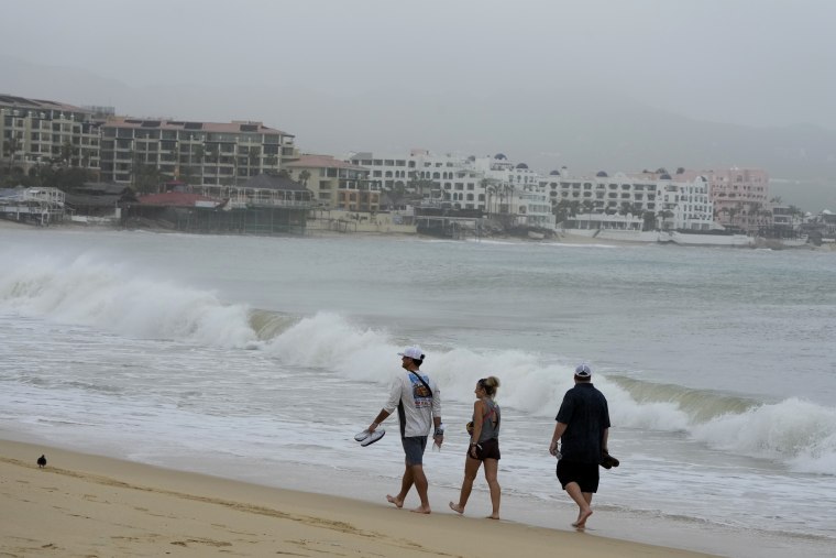 Tourists walk along the beach after Hurricane Norma passed by in Cabo San Lucas, Mexico, on Saturday.