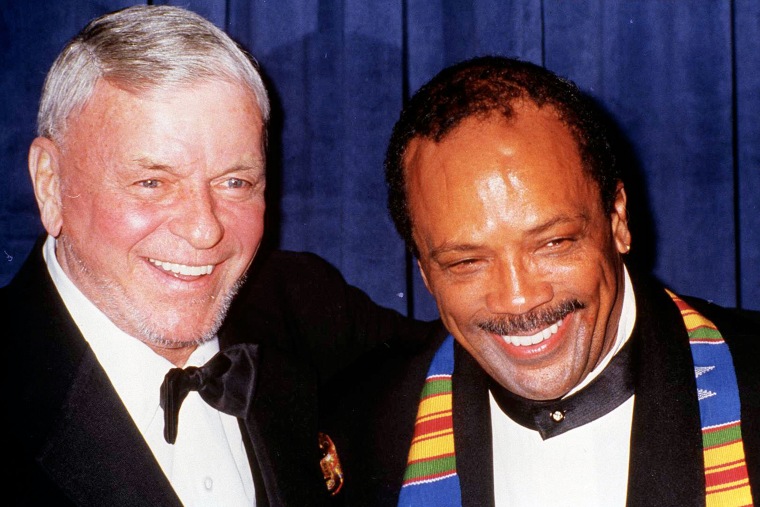 Frank Sinatra and Quincy Jones smile for a picture.