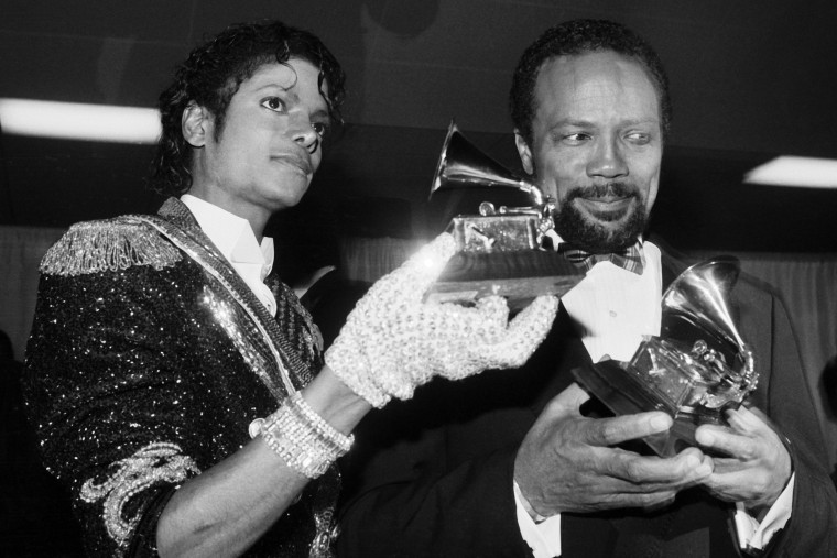 Michael Jackson and Quincy Jones hold their Grammy awards.