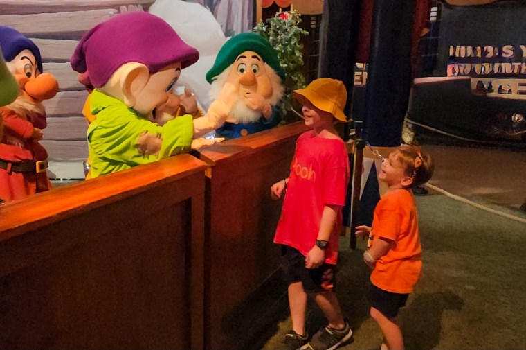 Drew Patchin, center, and his brother Tyler greet some of the Seven Dwarves at Disney World.