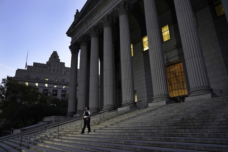 A court officer walks down the stairs in front of the New York Supreme Court in preparation for former President Donald Trump's arrival on Monday, Oct. 2, 2023.