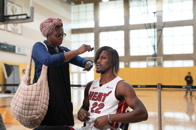 Miami Heat forward Jimmy Butler gets his new hairdo brushed 