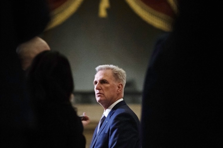 Republicans flank Kevin McCarthy as he talks to journalists at the Capitol