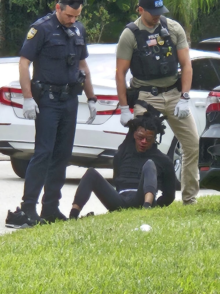  Le’Keian Woods surrounded by officers as he's taken into custody