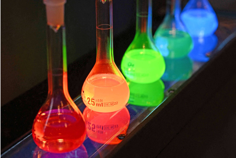 Laboratory flasks are used for explanation during the announcement of the winners of the 2023 Nobel Prize in chemistry 