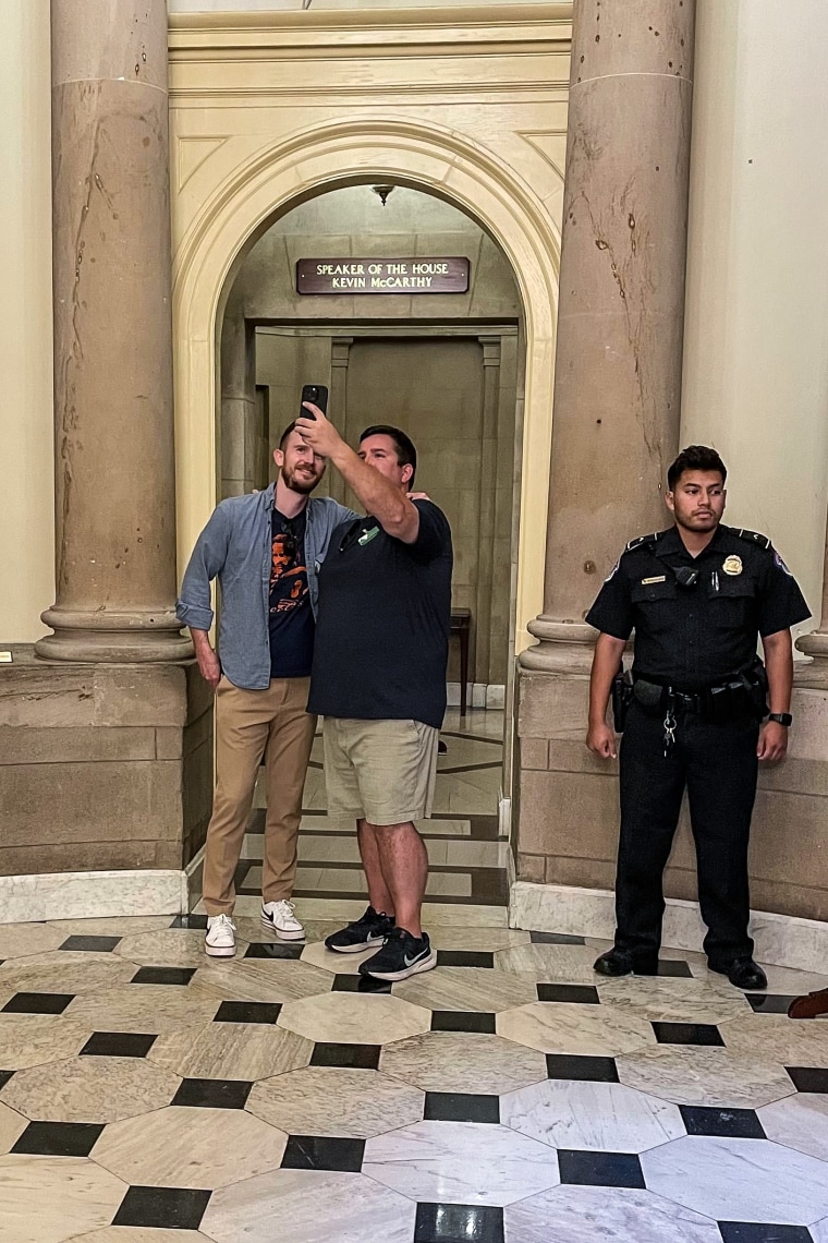 Tourists stop to take a selfie outside the offices of former Speaker of the House Kevin McCarthy, R-Calif., at the Capitol on Oct. 5, 2023.