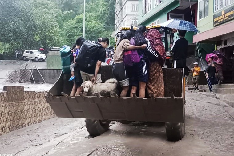At least 14 people were killed and 102 are missing after heavy rains caused a Himalayan glacial lake in northeast India to burst its banks, and rescuers were being hampered by washed out bridges and fast-flowing rivers, officials said Thursday.