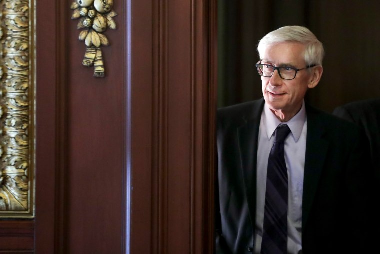 Gov. Tony Evers arrives to a ceremony at the State Capitol