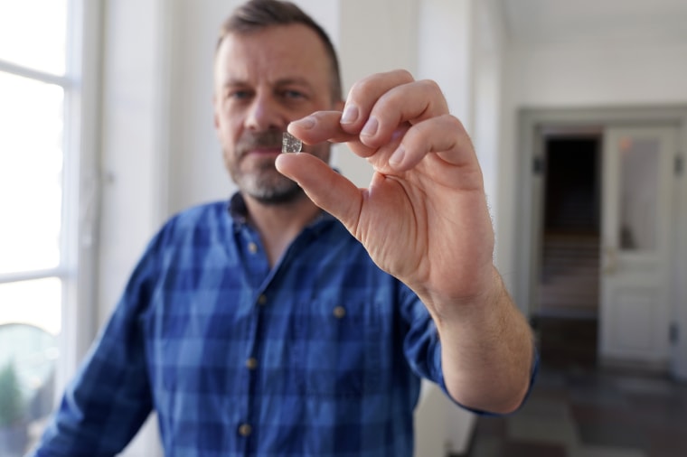 Mads Dengsø Jessen, a senior researcher at the National Museum of Denmark, holds a window glass fragment from the Viking Age.