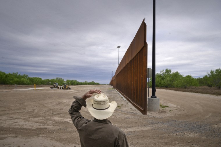 A ranch owner looks at portion of the unfinished border wall that former President Donald Trump tried to build, near the southern Texas border city of Roma in Starr County.