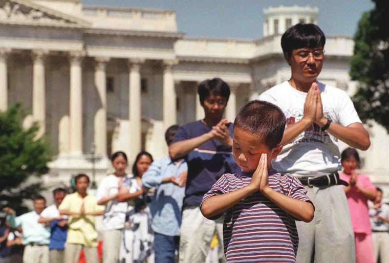 IMage: Falun Gong followers meditate outside the Capitol in Washington in 1999.