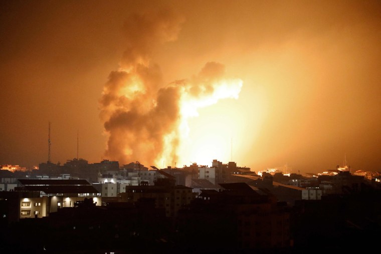 Fire and smoke rises above buildings during an Israeli air strike in Gaza City on Oct. 8, 2023. 