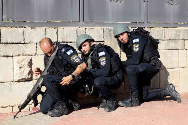 Image: Israeli forces take cover in Ashkelon as rockets fired from the Gaza Strip on Saturday.