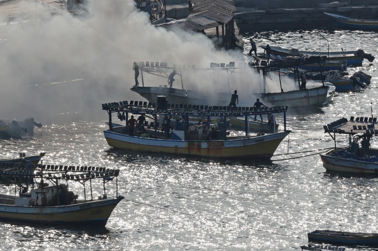 Smoke billows from a boat following Israeli strikes at the Gaza City port.