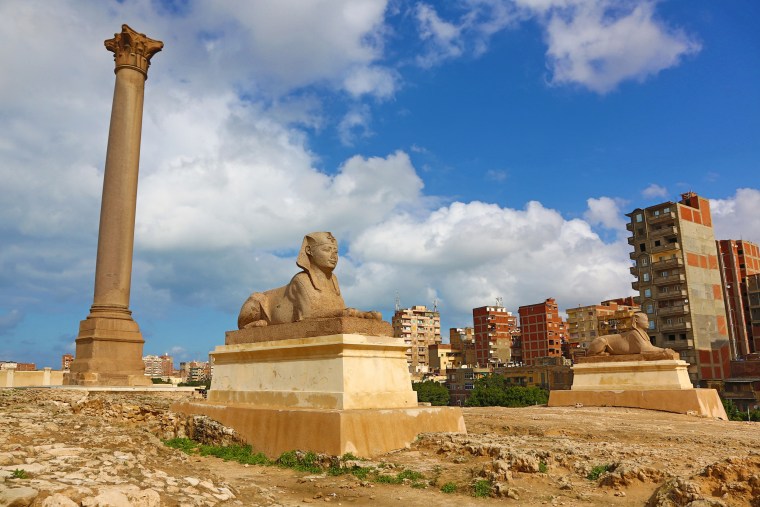 Pompey's Pillar, a triumphal memorial column, and Sphinx in the ancient necroplois of Alexandria, Egypt