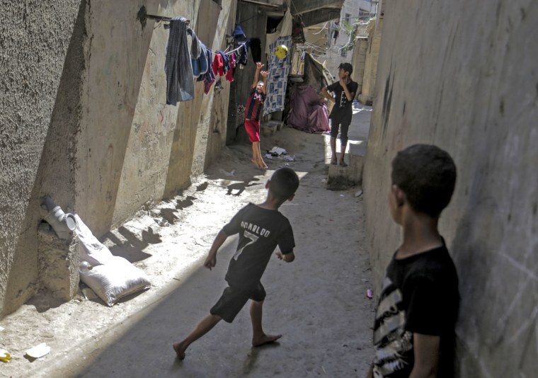 Palestinian children play outside their home in the Al-Shati refugee camp in the Gaza Strip in August 2023.
