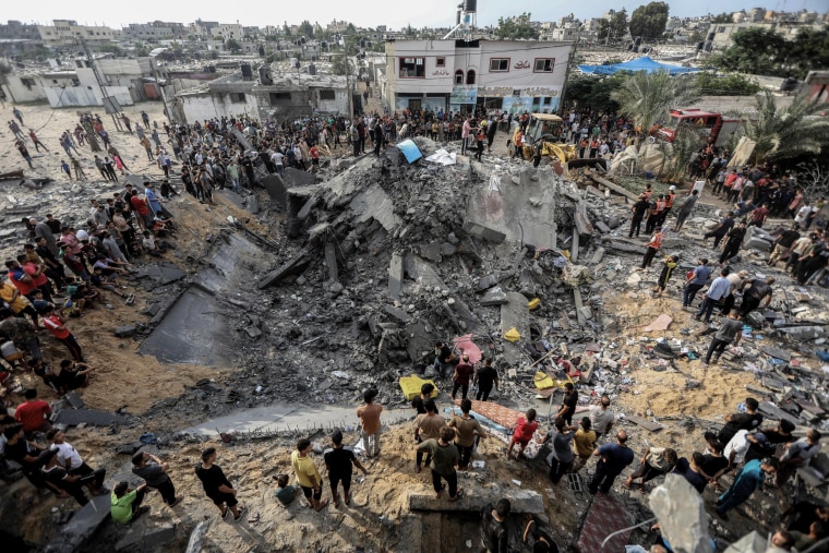 Palestinians inspect the rubble of a destroyed house, following an Israeli airstrike on Khan Yunis in the southern Gaza Strip on Oct. 9, 2023.