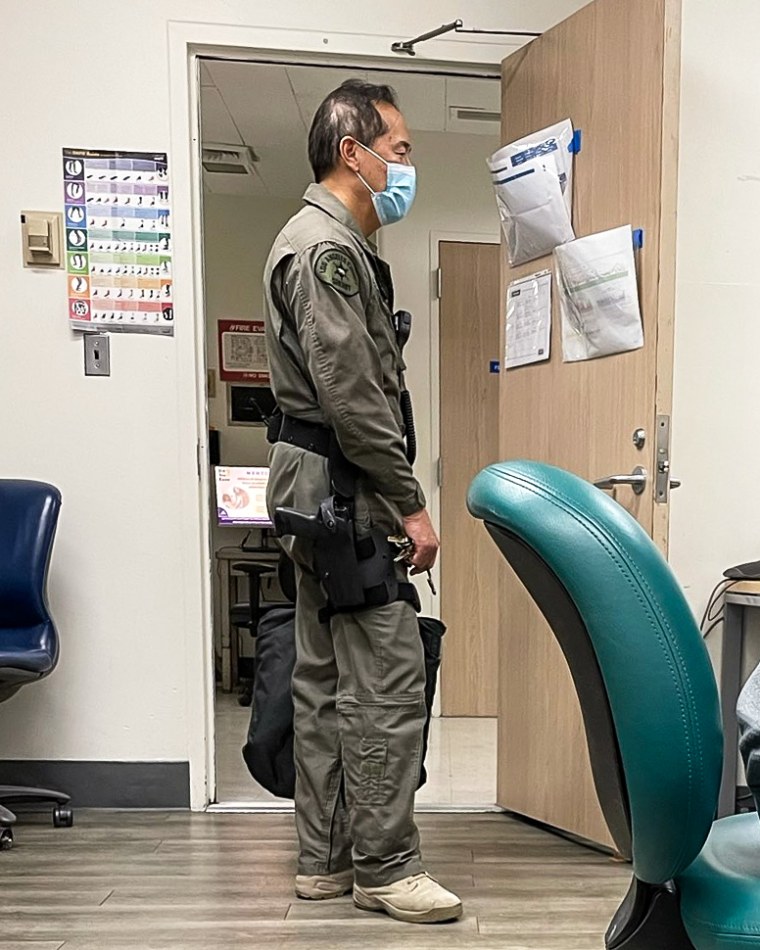 Dr. Lewis Kwong with a gun at work at the hospital. He is a volunteer deputy sheriff for L.A. County.