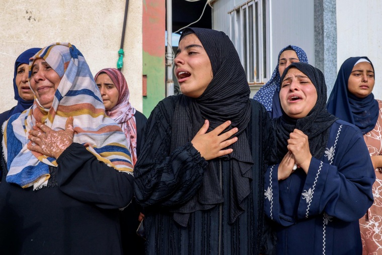 People mourn in Khan Yunis, Gaza, on Oct. 10, 2023.