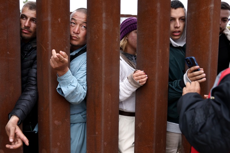 Immigrants at the border wall