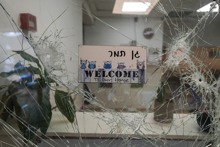 A bullet-shuttered window at the entrance to a kindergarten in Kibbutz Be'eri.