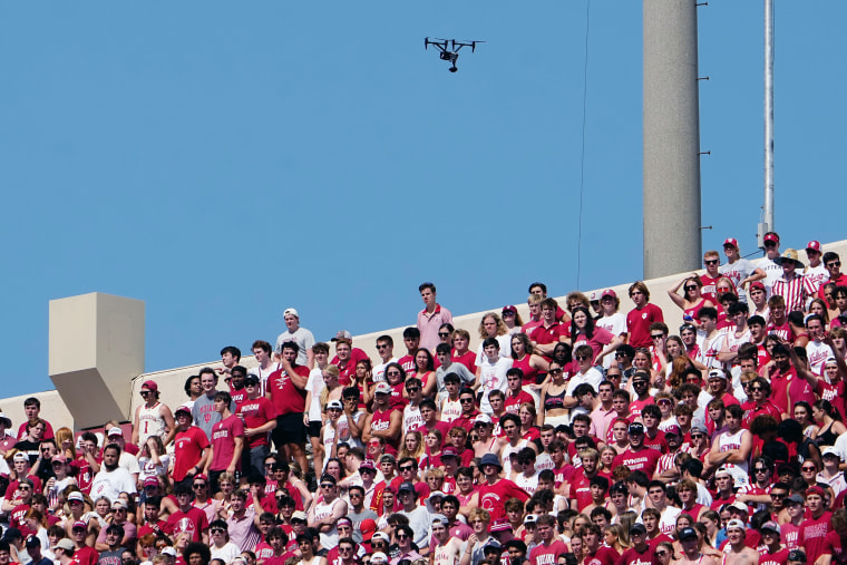 A drone flies above a stadium.
