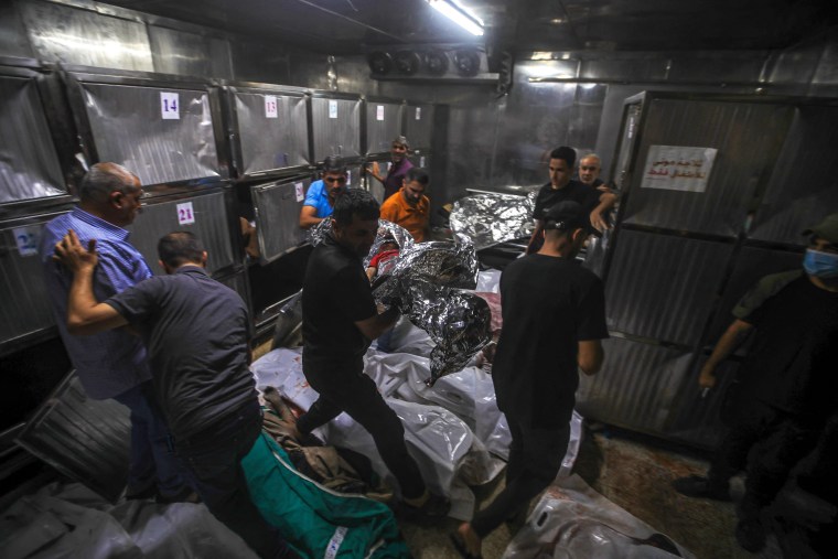 An interior view of Al-Shifa Hospital's morgue where the bodies are inside and people are still carring the bodies to the morgue. 