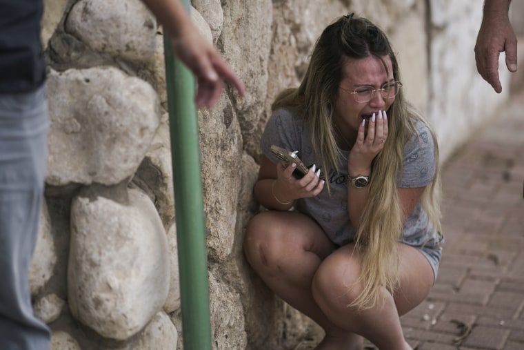 Israelis take cover from the incoming rocket fire from the Gaza in Ashkelon, Israel.