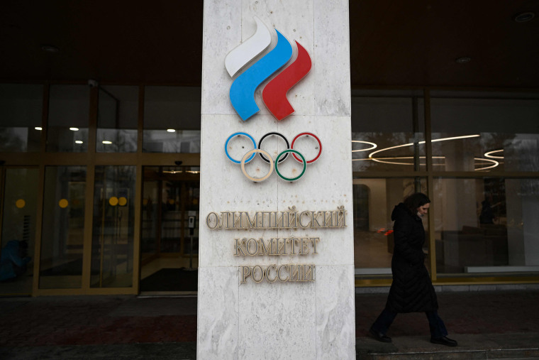 A woman walks past the Russian Olympic Committee headquarters in Moscow