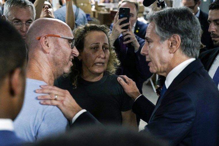 Secretary of State Antony Blinken speaks with people as he visits a donation center for victims of the Hamas terror attacks in Tel Aviv.