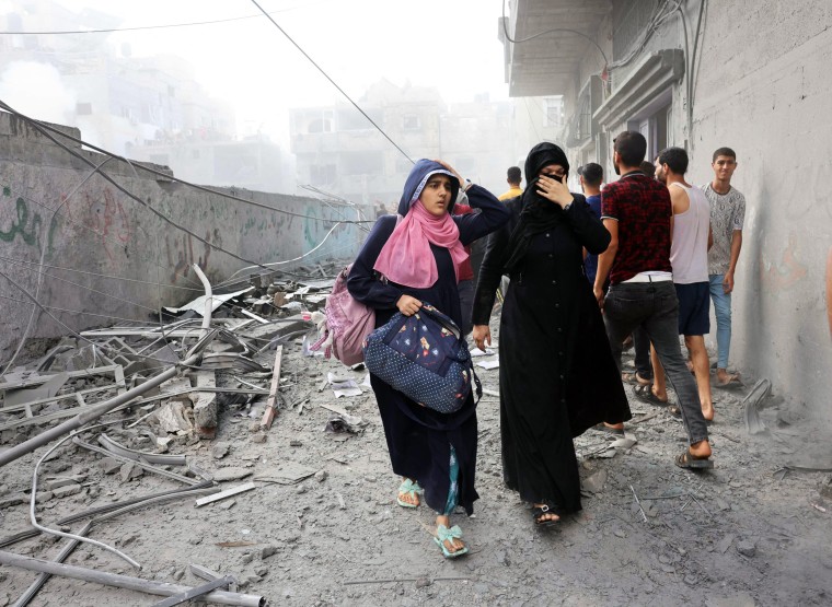Women flee after an Israeli strike in Rafah, Gaza