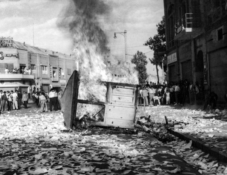 Image: A Communist newspaper kiosk burned by pro-shah demonstrators after the coup d'etat which ousted Prime Minister Mohammad Mossadegh