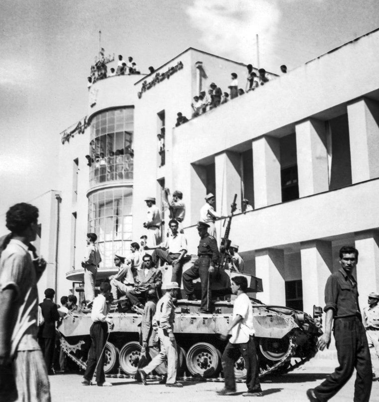 Image: A royalist tank moves into the courtyard of Tehran Radio a few minutes after pro-shah troops occupied the area during the coup which ousted Mohammad Mossadegh and his government on Aug. 19, 1953.