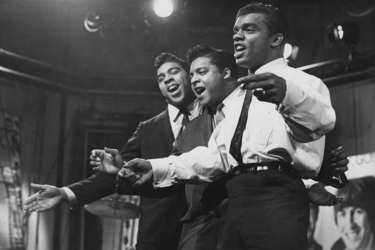 Rudolph, center, performs with his brothers Ronald and O'Kelly Isley, Jr. Isley