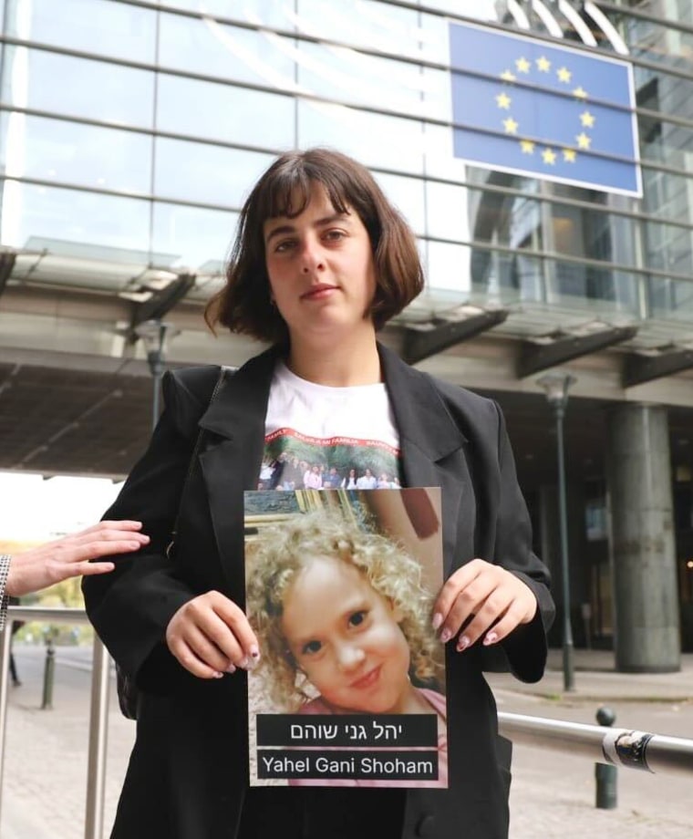 Shira Havron holds photo of her 3-year-old niece Yahel Gani Shoham in front of EU parliament holding