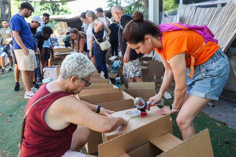 Volunteers pack boxes for soldiers  and evacuated people in Tel Aviv on Oct. 12, 2023.