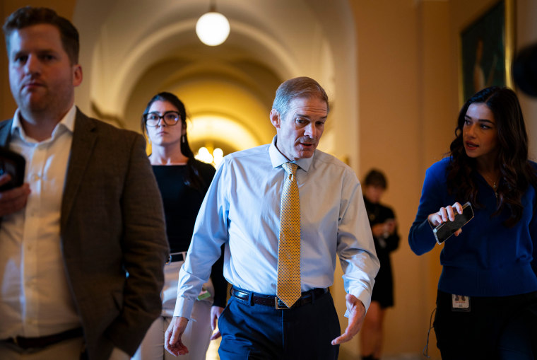Rep. Jim Jordan walks through a hallway of the Capitol while being interviewed by a reporter